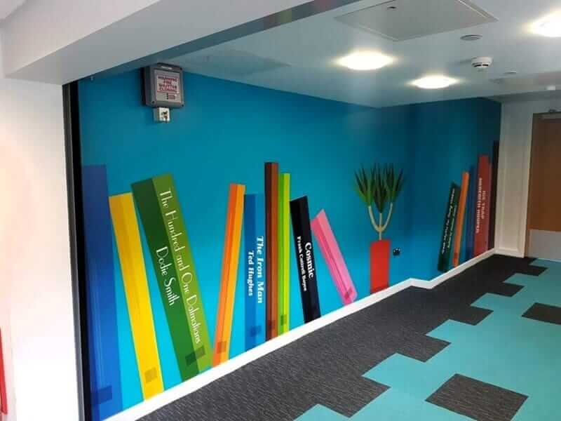 An image of a school's wall graphics made to look like giant books.